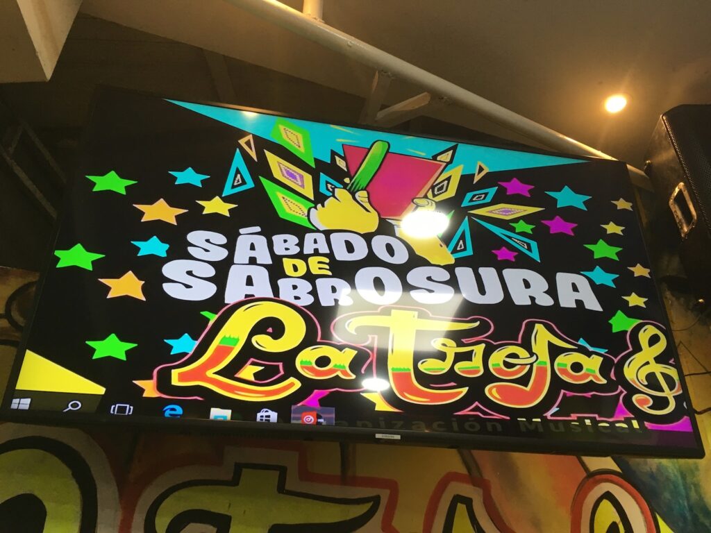 A large screen announces Sabado de Sabrosura at La Troja Salsero bar in Barranquilla, Colombia photo ©Kate Dana